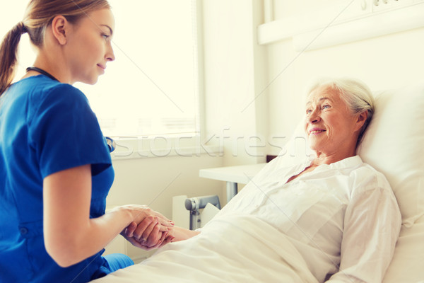 Stock photo: doctor or nurse visiting senior woman at hospital