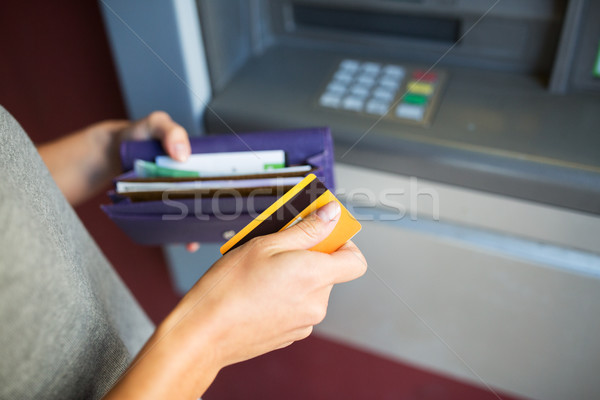 hands with money and credit card at atm machine Stock photo © dolgachov