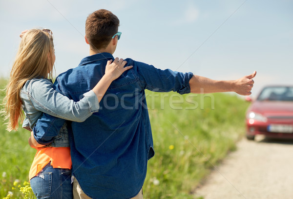 couple hitchhiking and stopping car on countryside Stock photo © dolgachov