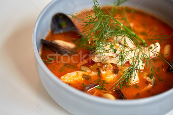 close up of seafood soup with fish and mussels Stock photo © dolgachov
