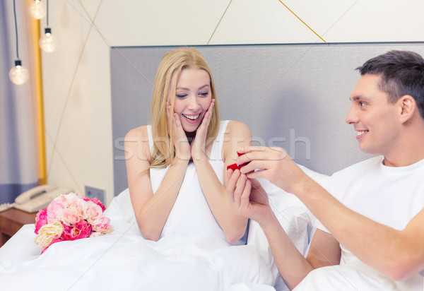 man giving woman little red box and ring in it Stock photo © dolgachov