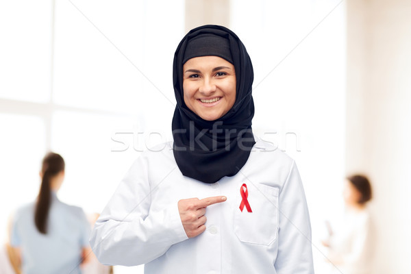 muslim doctor in hijab with red awareness ribbon Stock photo © dolgachov