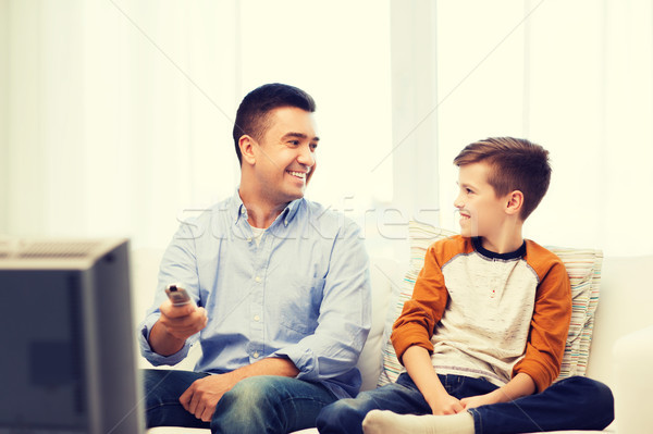 smiling father and son watching tv at home Stock photo © dolgachov