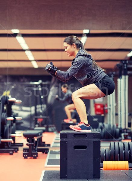 woman doing squats on pnatfom in gym Stock photo © dolgachov