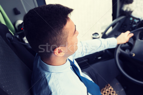 close up of driver driving passenger bus Stock photo © dolgachov
