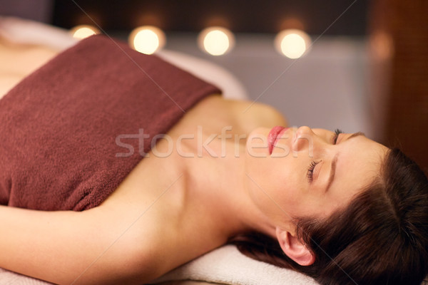happy young woman lying at spa or massage parlor Stock photo © dolgachov