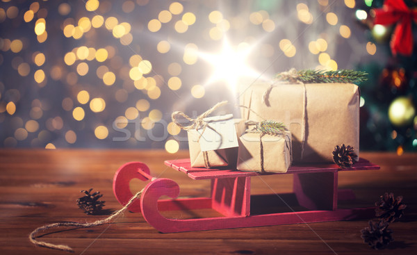 close up of christmas gift boxes on wooden sleigh Stock photo © dolgachov