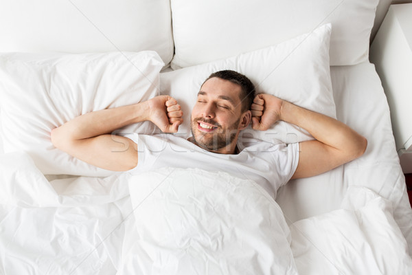 man lying in bed at home Stock photo © dolgachov