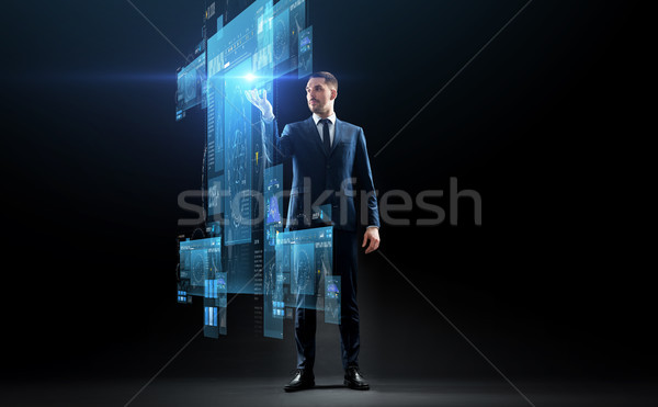 businessman in suit with virtual projection Stock photo © dolgachov