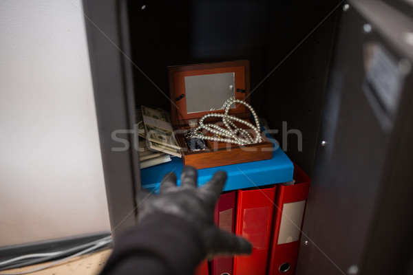 thief stealing valuables from safe at crime scene Stock photo © dolgachov