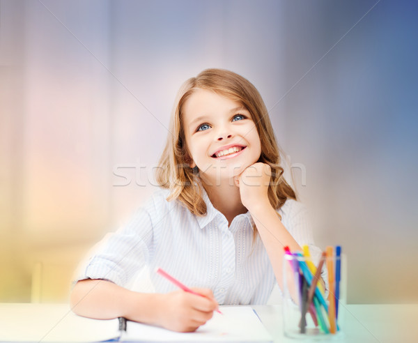 smiling little student girl drawing at school Stock photo © dolgachov