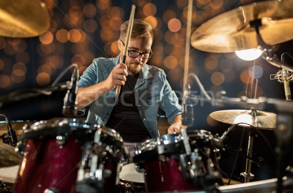 Stock photo: musician playing drum kit at concert over lights