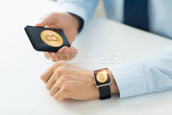 Stock photo: close up of bitcoin on smartphone and smart watch