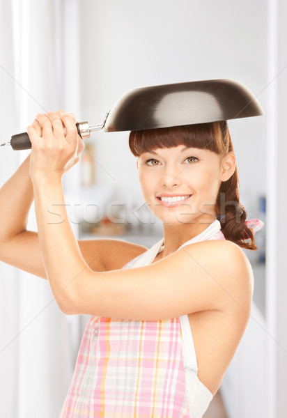 housewife with frying pan Stock photo © dolgachov