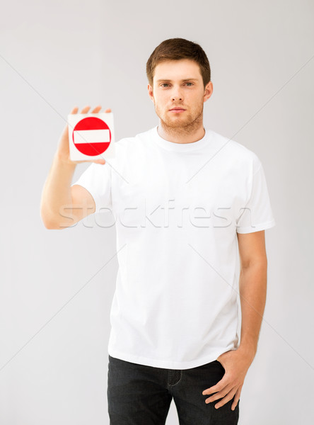 young man showing no entry sign Stock photo © dolgachov