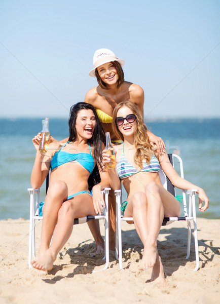girls with drinks on the beach chairs Stock photo © dolgachov