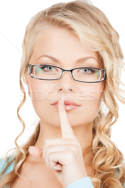 woman wearing eyeglasses with finger on her lips Stock photo © dolgachov