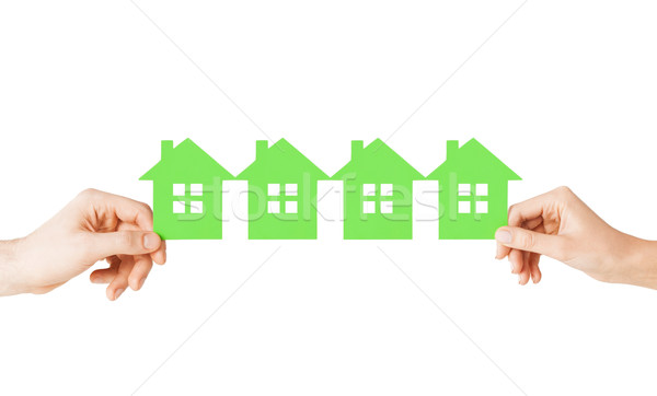 man and woman hands with many green paper houses Stock photo © dolgachov