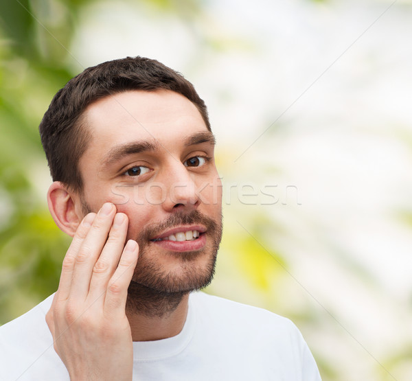 Schönen lächelnd Mann anfassen Gesicht Gesundheit Stock foto © dolgachov