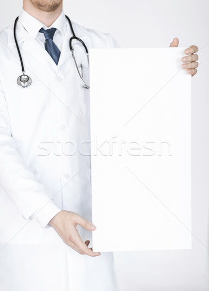 doctor holding blank white banner Stock photo © dolgachov