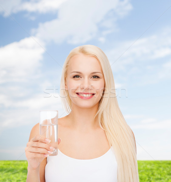 young smiling woman with glass of water Stock photo © dolgachov