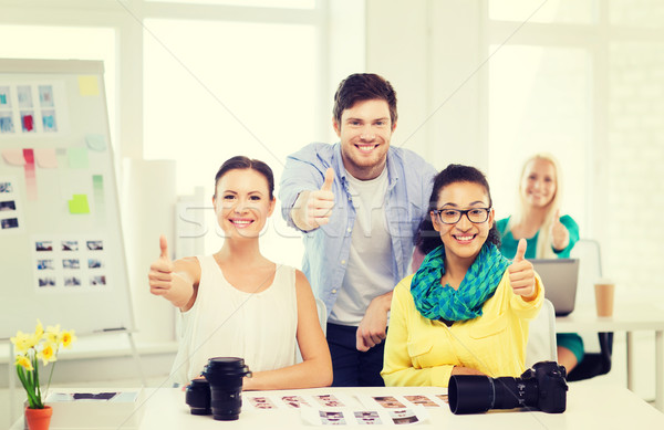 Stock photo: smiling team with photocamera in office