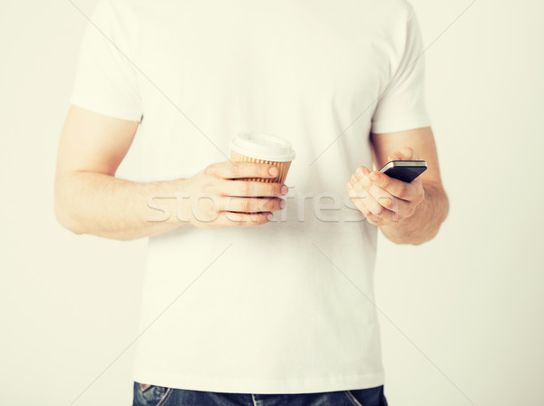 man with smartphone and coffee Stock photo © dolgachov