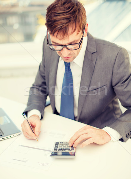 businessman with computer, papers and calculator Stock photo © dolgachov