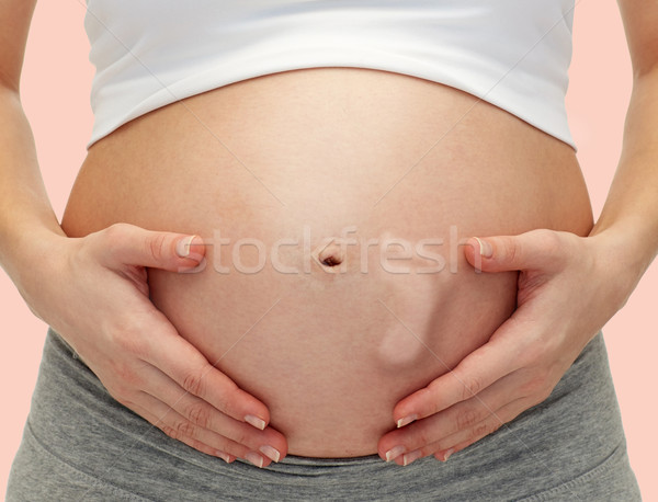 Mulher grávida tocante nu barriga gravidez Foto stock © dolgachov