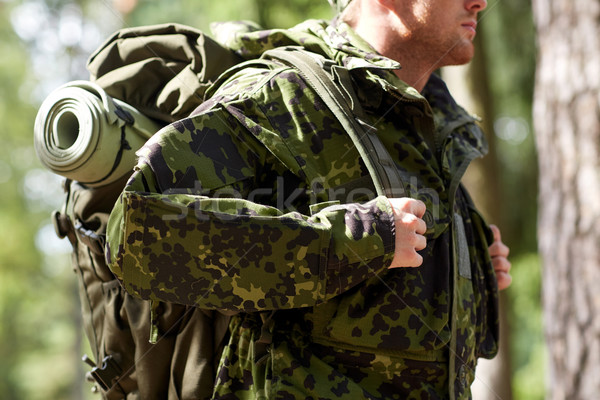 close up of young soldier with backpack in forest Stock photo © dolgachov