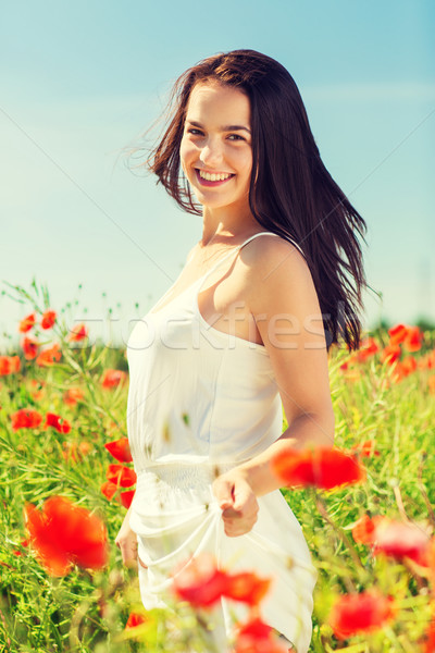 Sorridente mulher jovem papoula campo felicidade natureza Foto stock © dolgachov