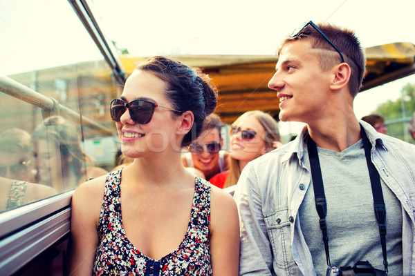 smiling couple with camera traveling by tour bus Stock photo © dolgachov