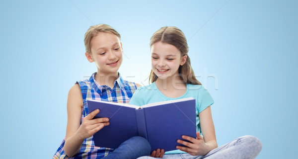 [[stock_photo]]: Deux · heureux · filles · lecture · livre · bleu