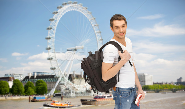 Stock photo: happy young man with backpack and book travelling
