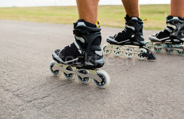 close up of legs in rollerskates skating on road Stock photo © dolgachov