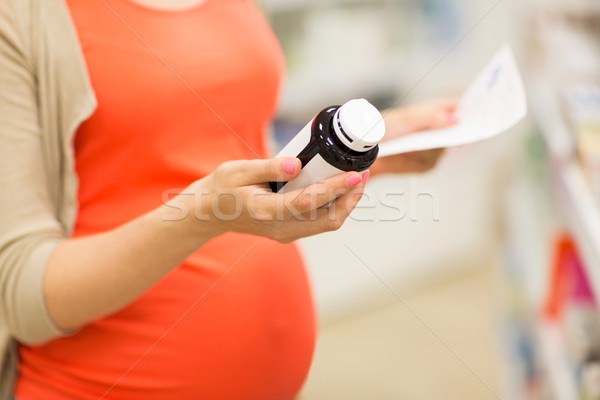 Kobieta w ciąży lek jar apteki ciąży muzyka Zdjęcia stock © dolgachov
