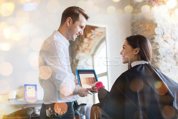 happy woman and stylist with tablet pc at salon Stock photo © dolgachov