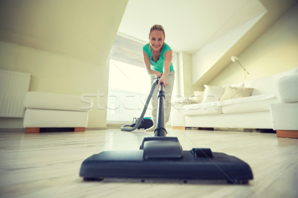 happy woman with vacuum cleaner at home Stock photo © dolgachov
