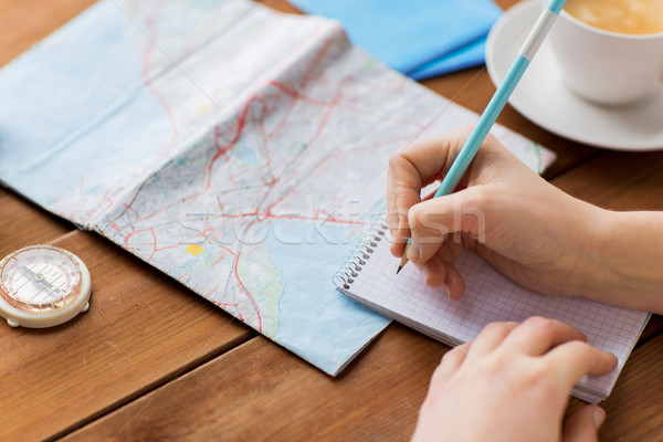 close up of traveler hands with notepad and pencil Stock photo © dolgachov