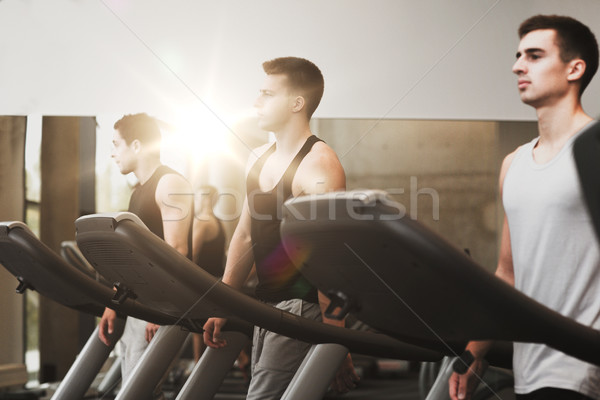 group of men exercising on treadmill in gym Stock photo © dolgachov
