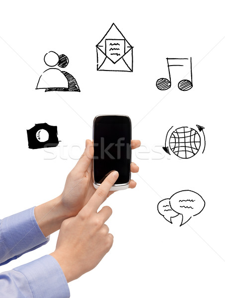 Stock photo: close up of hands with smartphone and doodles