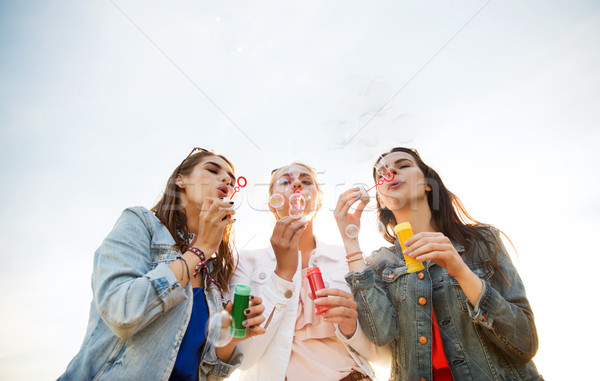 young women or girls blowing bubbles outdoors Stock photo © dolgachov