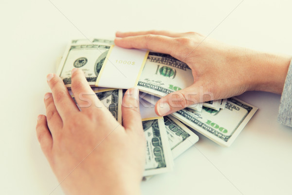 close up of woman hands counting us dollar money Stock photo © dolgachov