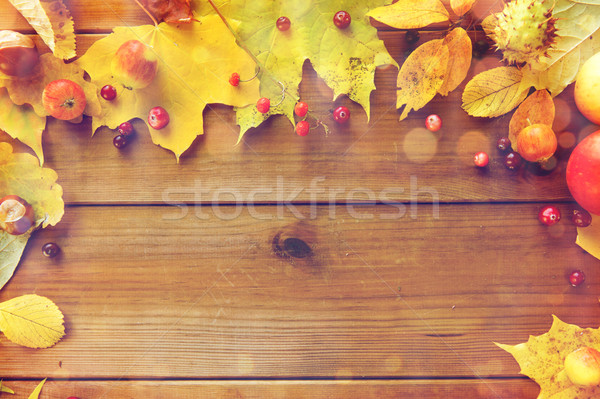 frame of autumn leaves, fruits and berries on wood Stock photo © dolgachov