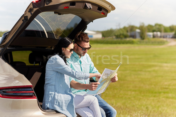 happy man and woman with road map at hatchback car Stock photo © dolgachov