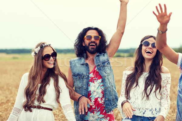 Stock photo: happy young hippie friends dancing on cereal field