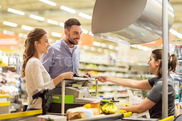 couple buying food at grocery store cash register Stock photo © dolgachov