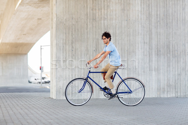 young hipster man riding fixed gear bike Stock photo © dolgachov