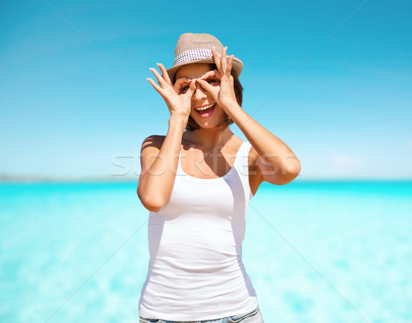 happy young woman in hat over blue sky and sea Stock photo © dolgachov