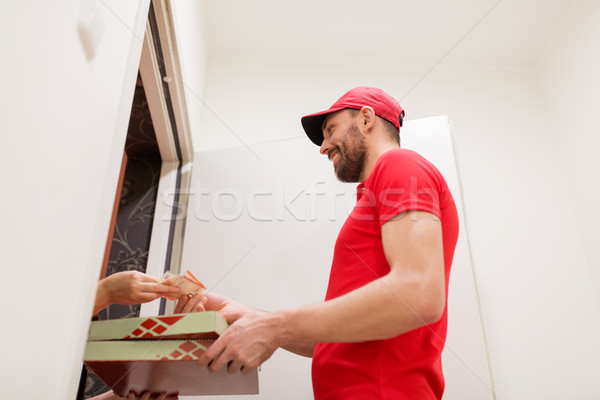 man delivering pizza to customer and taking money Stock photo © dolgachov